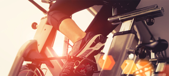 Close-up of a person pedaling an indoor cycling bike